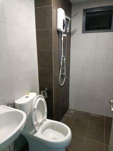 a bathroom with a toilet and a sink at Meritus Apartment in Perai