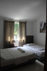 מיטה או מיטות בחדר ב-Quinta Baroe