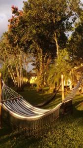 a hammock in the grass in a park at Village Colonial Pousada in Penedo