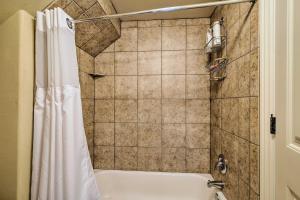 La salle de bains est pourvue d'une baignoire et d'un rideau de douche. dans l'établissement Fayetteville Apt by Univ of Arkansas Campus!, à Fayetteville 18 autres photos