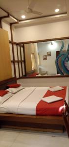 a bedroom with a bed with a large mirror at Hotel Aston in Kolkata