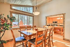 a kitchen and dining room with a wooden table and chairs at Pagosa Springs Gem with Yard, Decks and Mtn Views! in Pagosa Springs