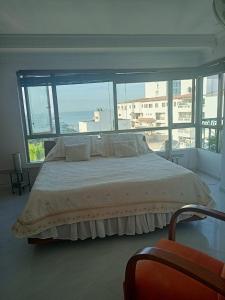 a bedroom with a large bed with a large window at Apartment Bello Horizonte in Santa Marta +110 photos