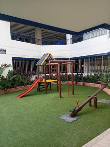 a playground with a slide and a swing set at Apartment Bello Horizonte in Santa Marta