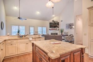a large kitchen with wooden cabinets and a large island at Upscale Home with Poker Room Less Than 1 Mi to Golf! in Aiken