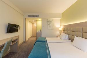 Кровать или кровати в номере Nesterov Plaza Hotel