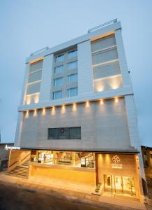 a large building with lights on the side of it at IKON By Annapoorna in Coimbatore