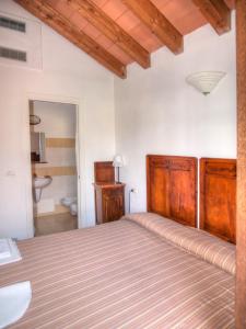a bedroom with a large bed and a bathroom at Agriturismo Ca' Di Trincia in Pietra Ligure