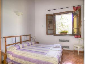 a bedroom with a bed and a window at Agriturismo Ca' Di Trincia in Pietra Ligure