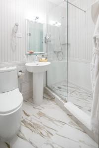 a bathroom with a toilet and a sink and a shower at Mozart Hotel in Odesa