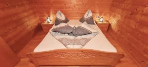 a bed in a wooden room with at Appartement Gugganig in Flattach