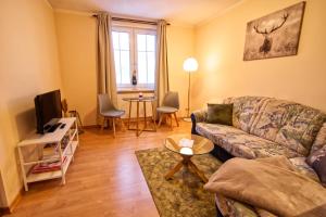 a living room with a couch and a table at Haus Susanne in Oberhof