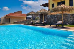 basen z dwoma krzesłami i dom w obiekcie Siena Pool Villa w mieście Koskinou +30 zdjęć