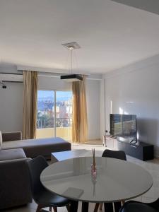 a living room with a table and a couch at Downtown Apartment in Vlorë