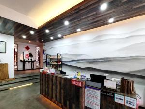 a store with a large painting on the wall at Hongcun Garden Villa Yododo Inn in Yi