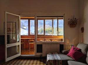 a living room with a couch and a large window at La finestra sul Matese in San Massimo