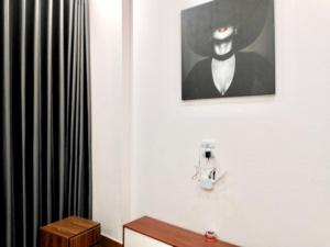 a bathroom with a picture of a man in a suit at Ngoc Khanh Hotel in Việt Yên