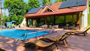 a house with a swimming pool with a solar roof at Chalupa u Bohumila in Rybná nad Zdobnicí