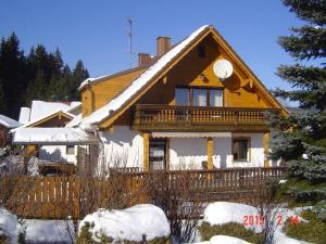 a wooden house with snow on the roof at Haus-Johanna-2 in Riedlhütte