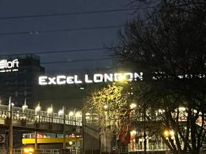 a lit up sign on top of a building at night at Lovely 2 bedroom apartment with parking space in London