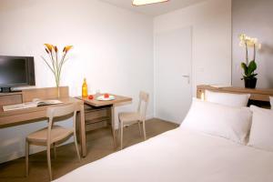 Tempat tidur dalam kamar di Terres de France - Appart'Hotel Quimper Bretagne