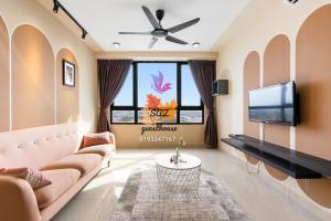 a living room with a couch and a tv at SAZ Guesthouse in Semenyih