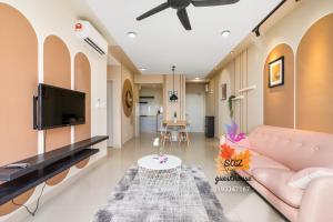 a living room with a couch and a tv at SAZ Guesthouse in Semenyih