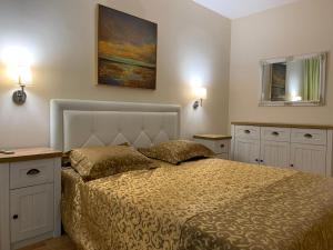 a bedroom with a bed and a painting on the wall at Elite Apartments in Sunny Beach