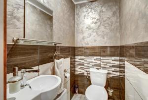 a bathroom with a white toilet and a sink at Zaļais Stūrītis in Liepāja