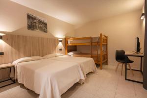 a bedroom with a large white bed and a desk at Hotel Encamp in Encamp