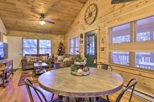 a living room with a table and chairs at Cozy Noras Hideaway - Charming, Quiet Log Cabin in Duck Creek Village