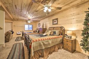 a bedroom with a bed and a ceiling fan at Cozy Noras Hideaway - Charming, Quiet Log Cabin in Duck Creek Village