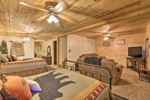 a living room with two beds and a tv at Cozy Noras Hideaway - Charming, Quiet Log Cabin in Duck Creek Village