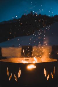 a fire pit at night with a view at Hotel Villa Waldheim in San Candido