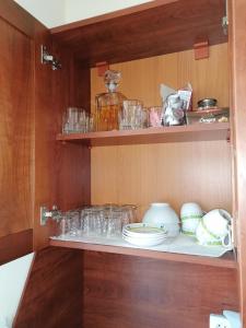 a cupboard with glasses and dishes on it at iVΛVƏV CedarLodge Bansko in Bansko