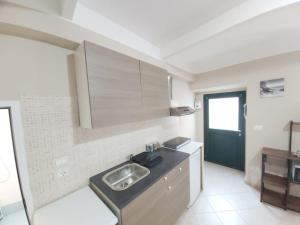a kitchen with a sink and a counter at Casa Doria in Alassio +9 photos