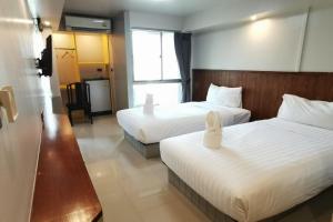 מיטה או מיטות בחדר ב-A Sleep Bangkok Sathorn