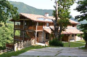 a large house with a balcony and a tree at Arantza Apartamentuak in Arantza
