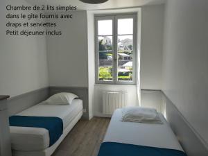 Postel nebo postele na pokoji v ubytování Gîte Les Pieds dans l'Olt - Ultreïa