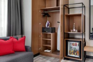 a living room with a couch and a fireplace at Ramada by Wyndham Budapest City Center in Budapest