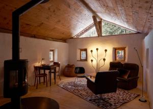 a living room with a vaulted ceiling with a fireplace at Stalla d' Immez in Santa Maria Val Müstair