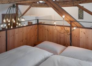 a bedroom with two beds and a chandelier at Stalla d' Immez in Santa Maria Val Müstair