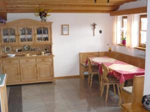 a kitchen with a table and a cross on the wall at Ferienwohnung Eder in Mauth