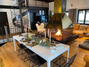 a living room with a white table and a fireplace at Beautiful Chalet on the piste in Swiss Alps in Alt Sankt Johann