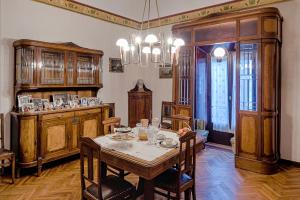 a dining room with a table and chairs and a chandelier at antica bifora rsm in San Marino