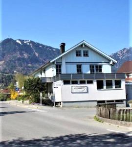 a large white building on the side of a street at Apartments ChezTom Nenzing in Nenzing