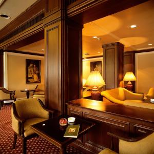 a hotel room with a couch and a table at Trident Chennai in Chennai