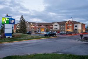 a sign in a parking lot in front of a building at Holiday Inn Express & Suites Rapid City by IHG in Rapid City