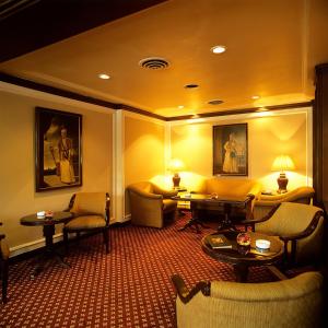 a hotel room with couches and tables and chairs at Trident Chennai in Chennai