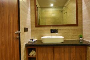 a bathroom with a sink and a mirror at Hotel Rock Regency Mount Abu - A Boutique Rodetel in Mount Ābu +50 photos